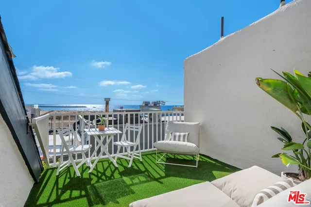 a view of a balcony with chairs