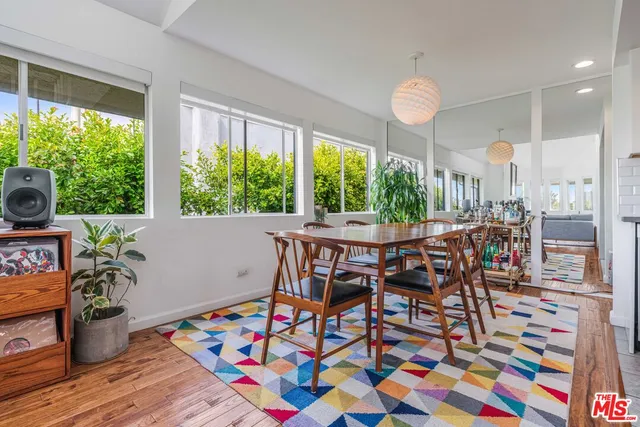 a view of a dining room with furniture window and wooden floor