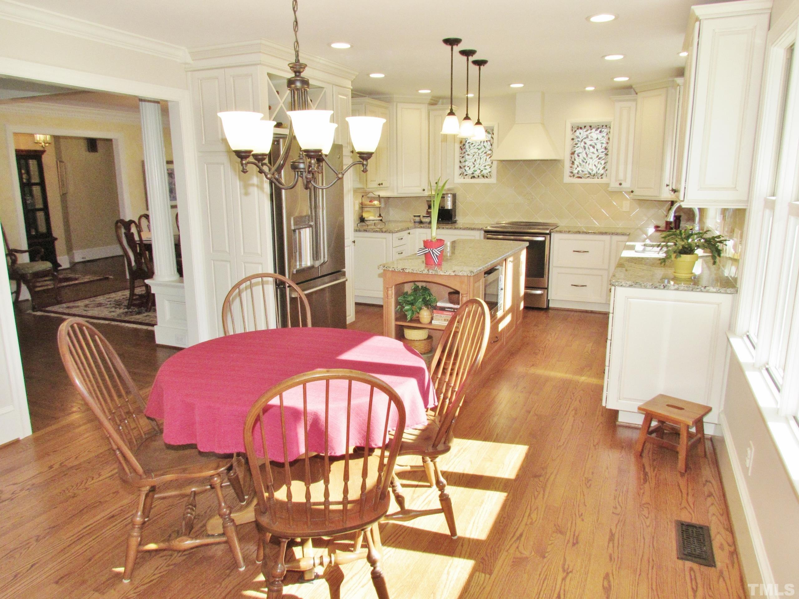 12001 Pembridge Lane Raleigh, NC 27613 - Photo 11 of 53 a view of a dining room with furniture and wooden floor
