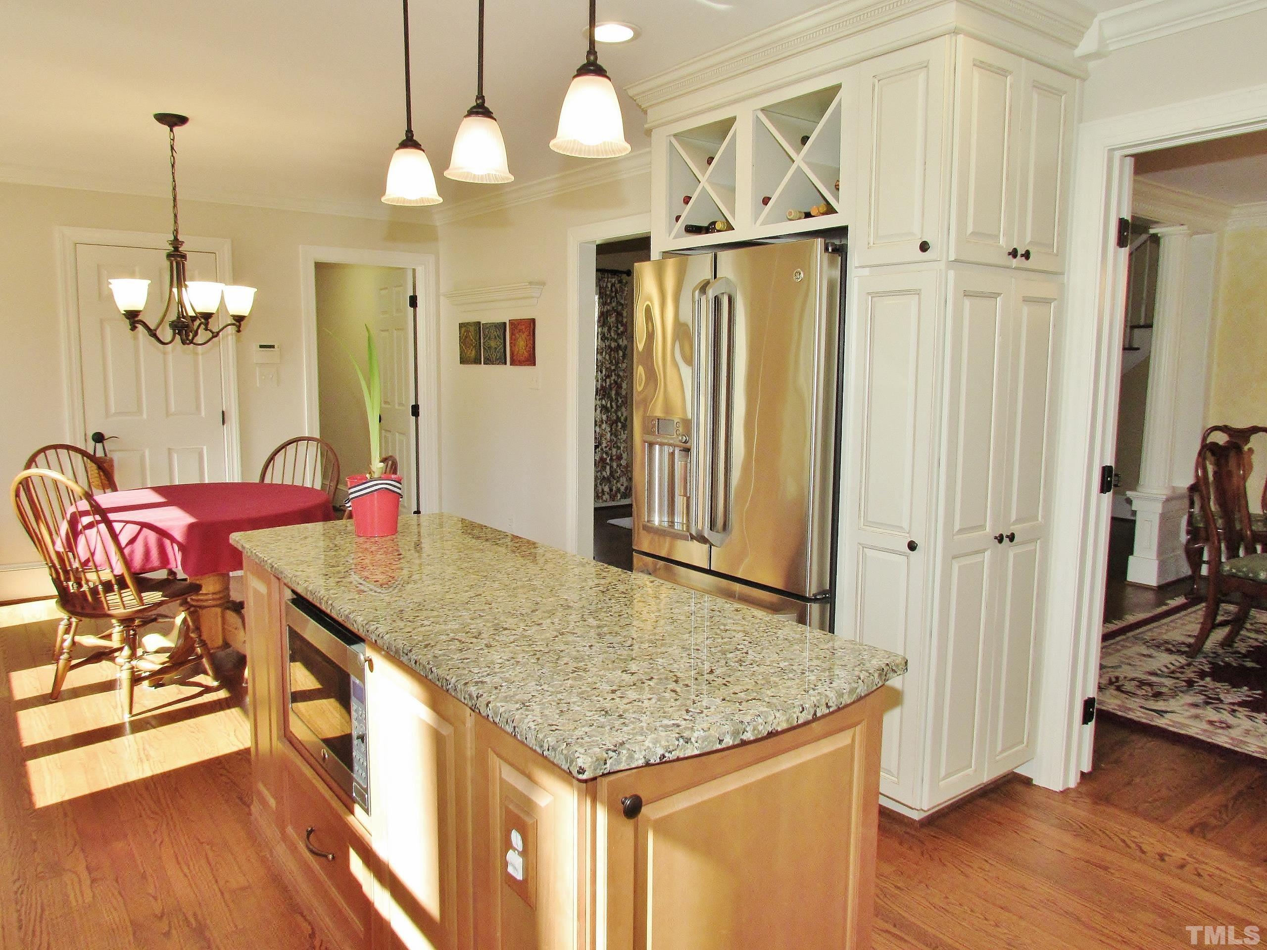 12001 Pembridge Lane Raleigh, NC 27613 - Photo 12 of 53 a kitchen area with stainless steel appliances granite countertop furniture and wooden floor