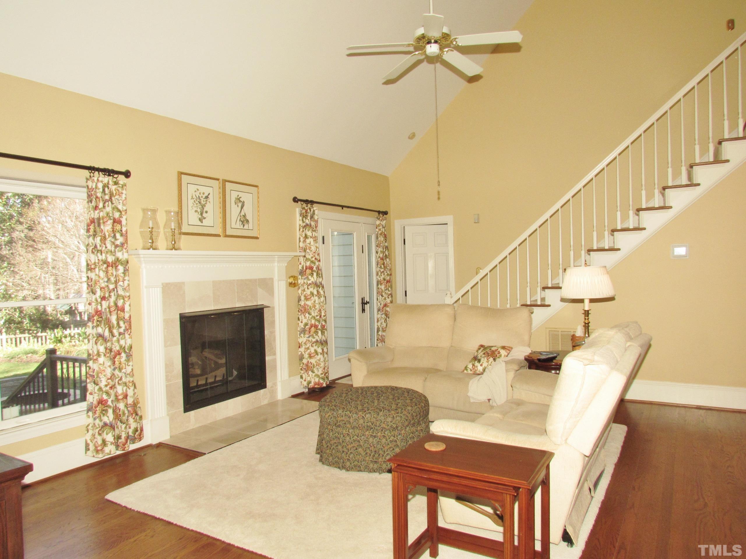 12001 Pembridge Lane Raleigh, NC 27613 - Photo 17 of 53 a living room with furniture and a fireplace
