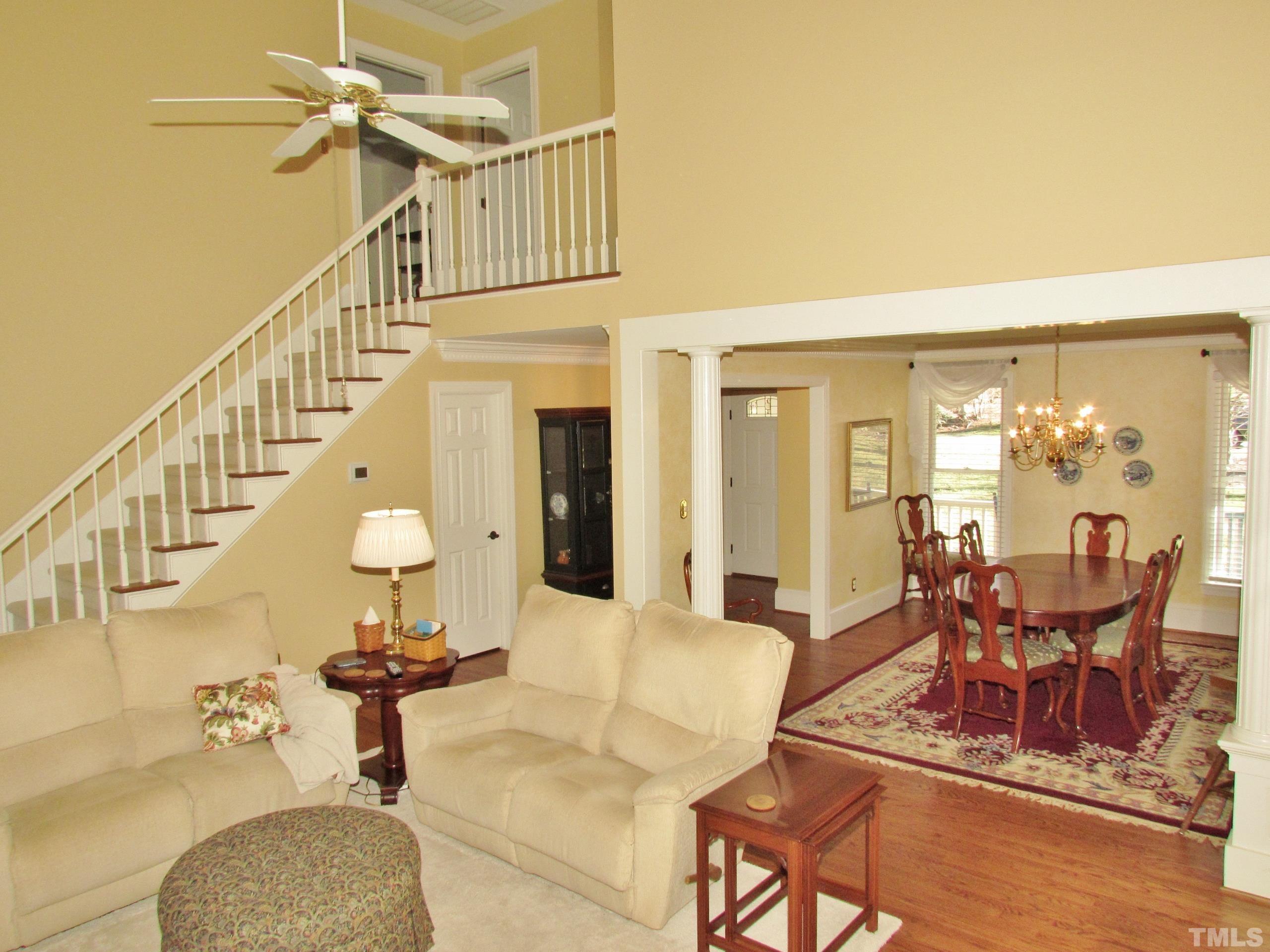 12001 Pembridge Lane Raleigh, NC 27613 - Photo 18 of 53 a living room with couches chairs and a dining table with garden view