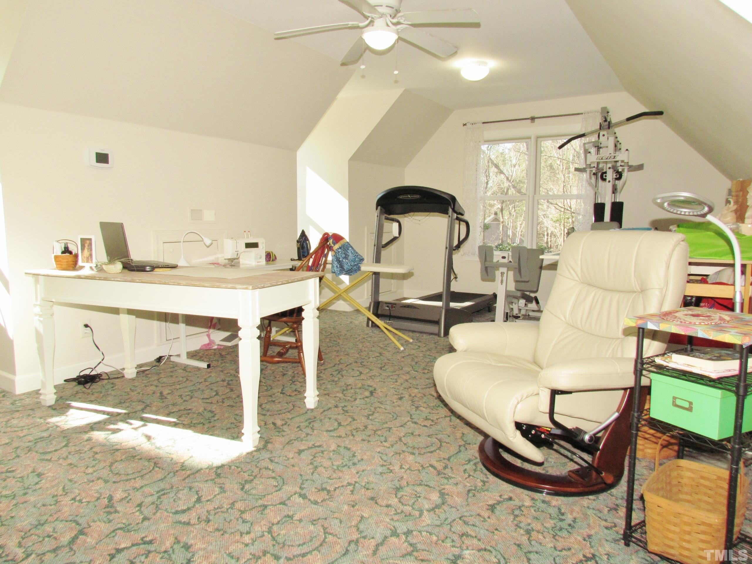 12001 Pembridge Lane Raleigh, NC 27613 - Photo 20 of 53 a room with furniture a rug and white walls