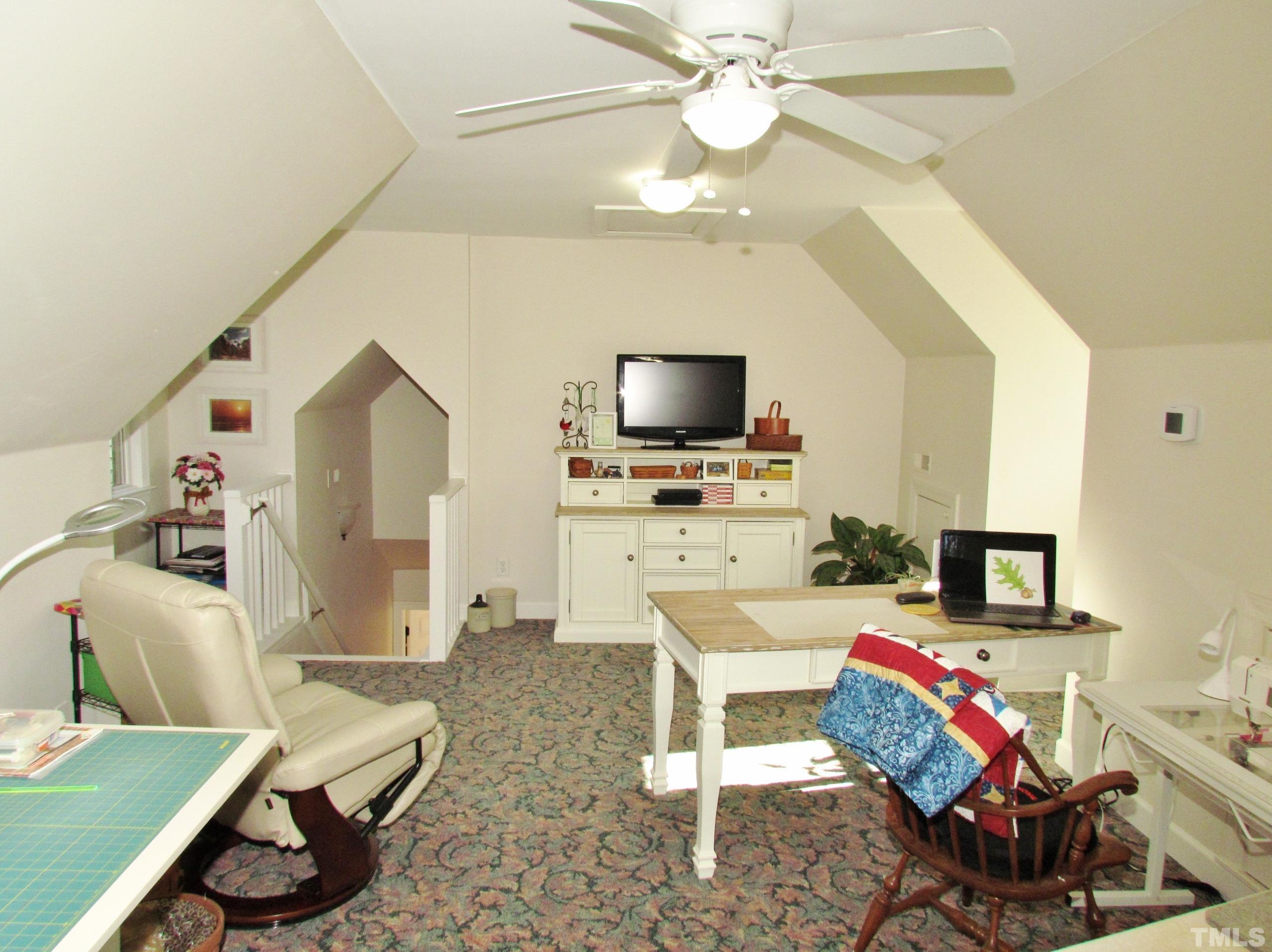 12001 Pembridge Lane Raleigh, NC 27613 - Photo 21 of 53 a living room with furniture and a flat screen tv