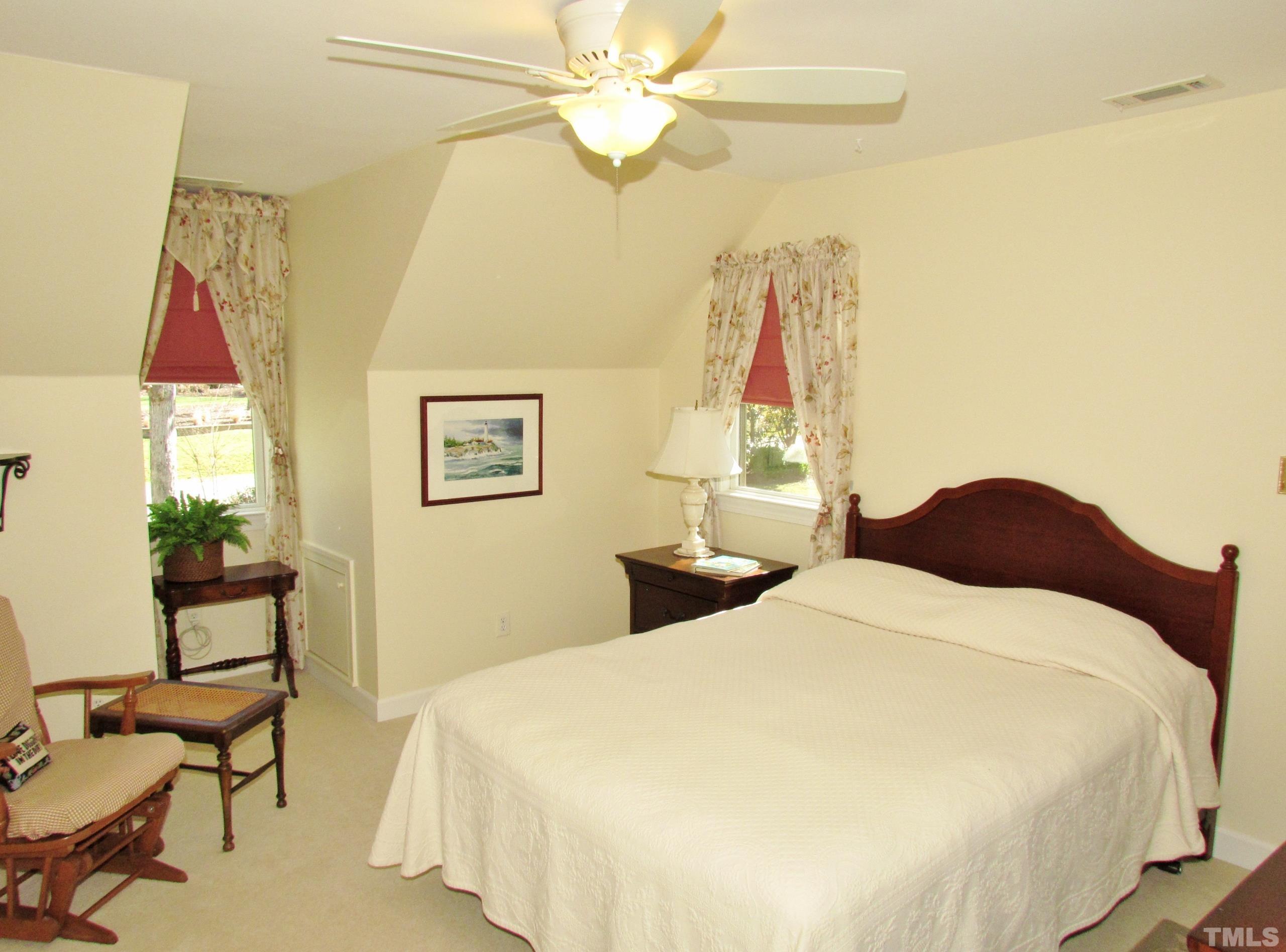 12001 Pembridge Lane Raleigh, NC 27613 - Photo 31 of 53 a bedroom with a bed and a chandelier