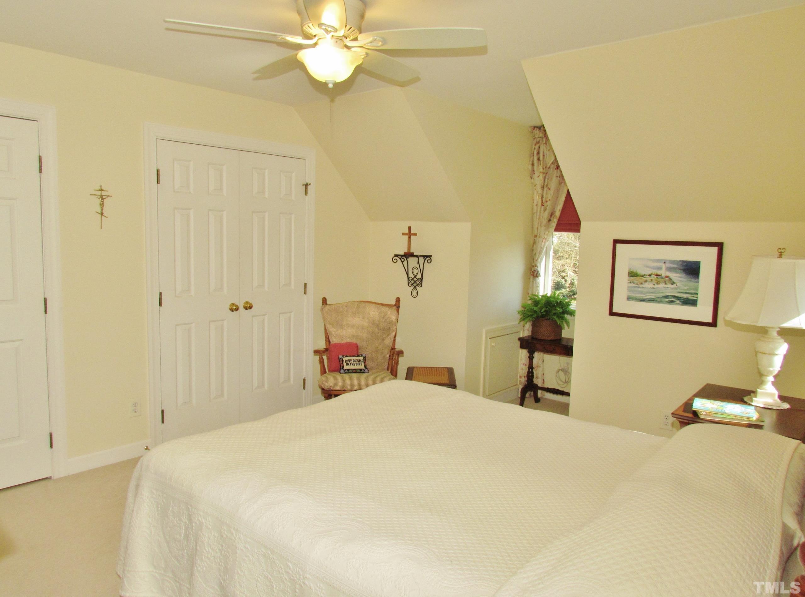 12001 Pembridge Lane Raleigh, NC 27613 - Photo 33 of 53 a bedroom with a bed and a chandelier