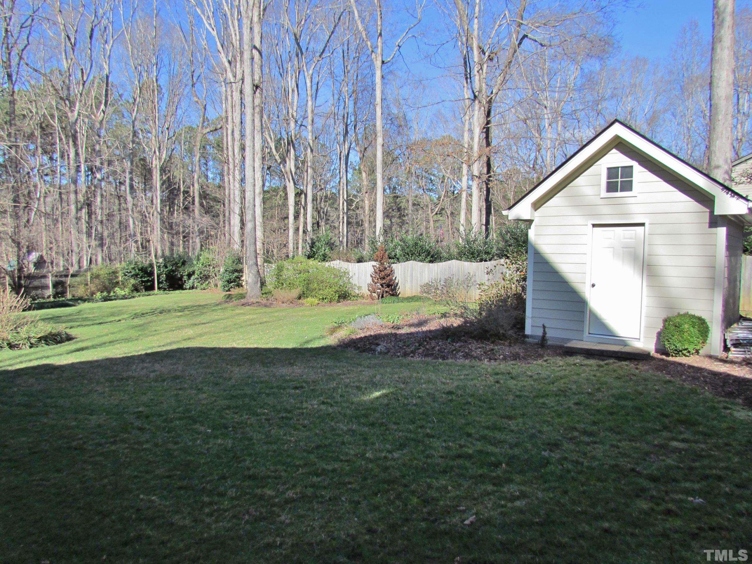 12001 Pembridge Lane Raleigh, NC 27613 - Photo 43 of 53 a front view of a house with a yard and garage