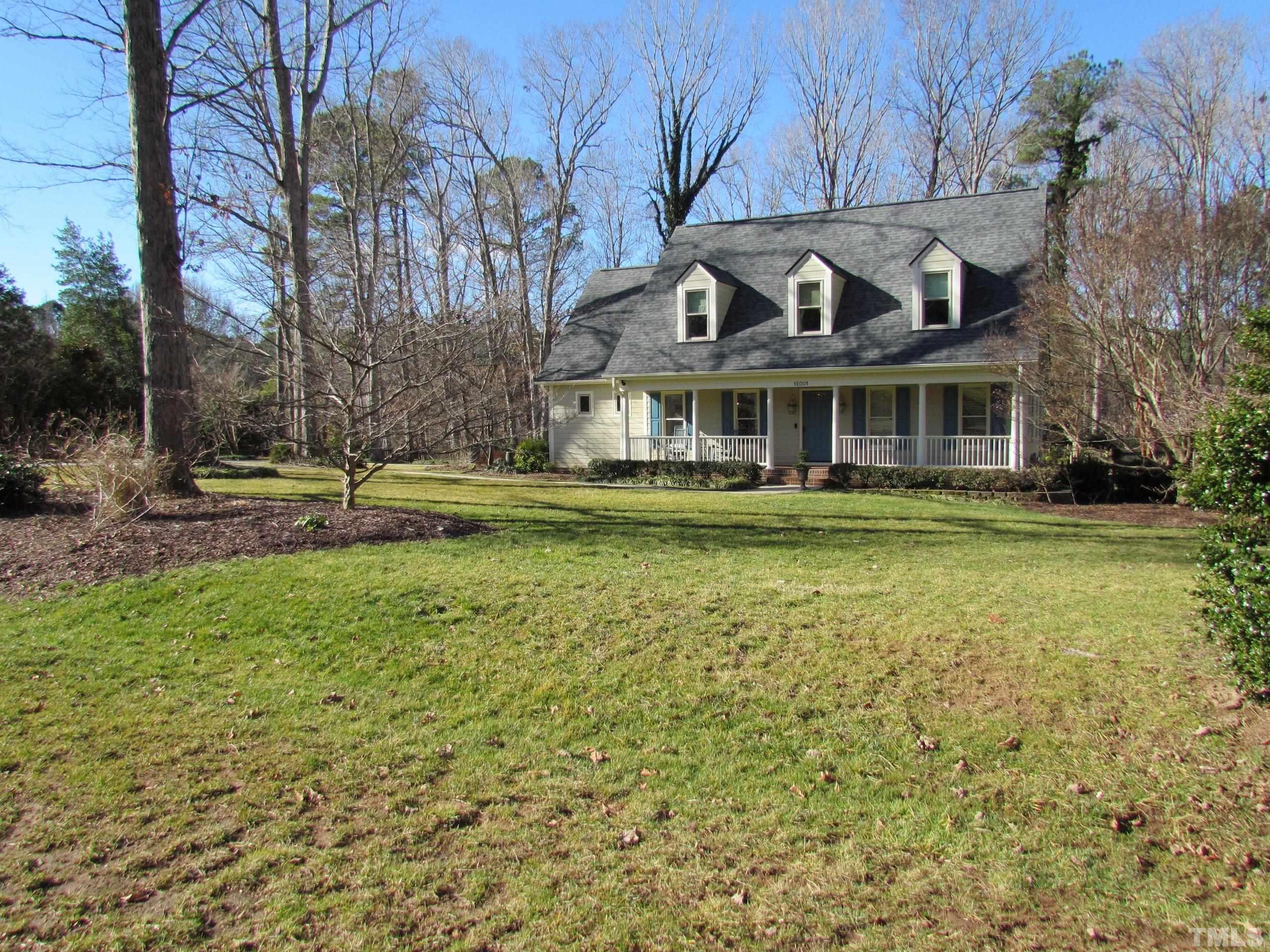 12001 Pembridge Lane Raleigh, NC 27613 - Photo 7 of 53 a front view of a house with a garden and trees