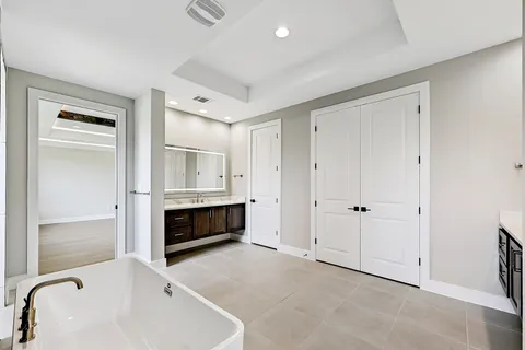 a spacious bathroom with a tub and a sink