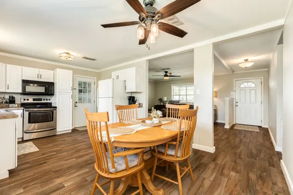 a view of a dining room with furniture and wooden floor