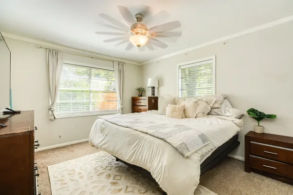 a bedroom with a large bed and a chandelier