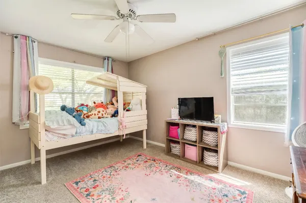 a bedroom with bed and a window