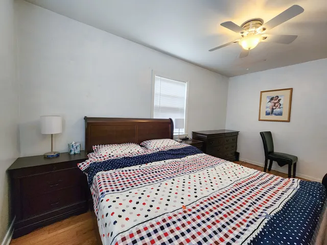 a bedroom with a bed and a chandelier