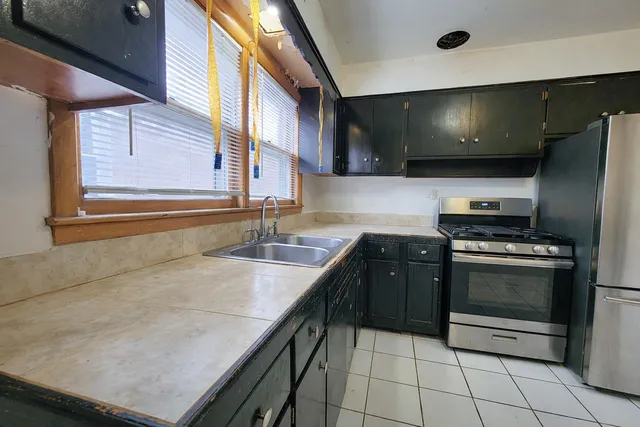 a kitchen with kitchen island granite countertop a sink and a stove