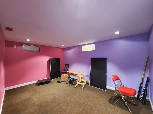 a room with furniture and a projector screen