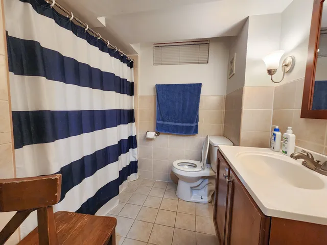 a bathroom with a sink a toilet a shower and a mirror