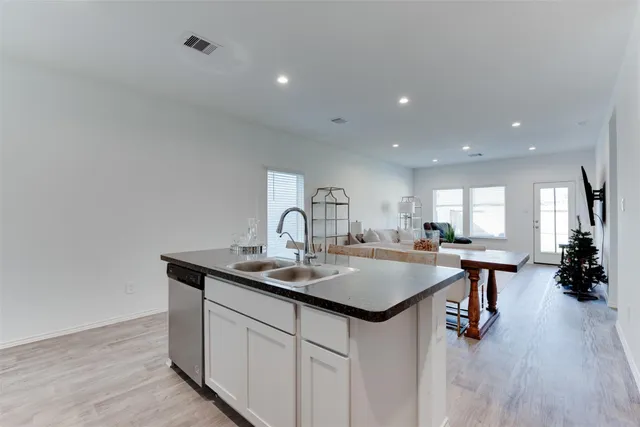 a kitchen with stainless steel appliances granite countertop a sink a stove and center island