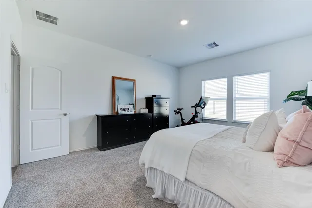 a bedroom with bed and a dresser