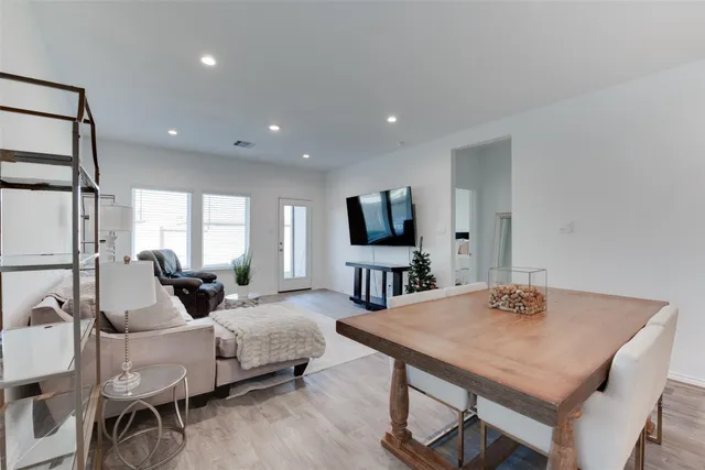 a living room with furniture a flat screen tv and a large window