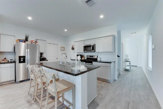 a living room with furniture a flat screen tv and a table