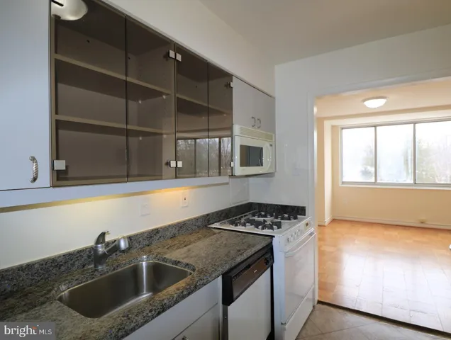 a kitchen that has a sink and a stove