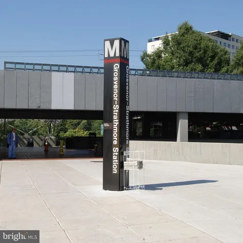 a view of a street with potted plants
