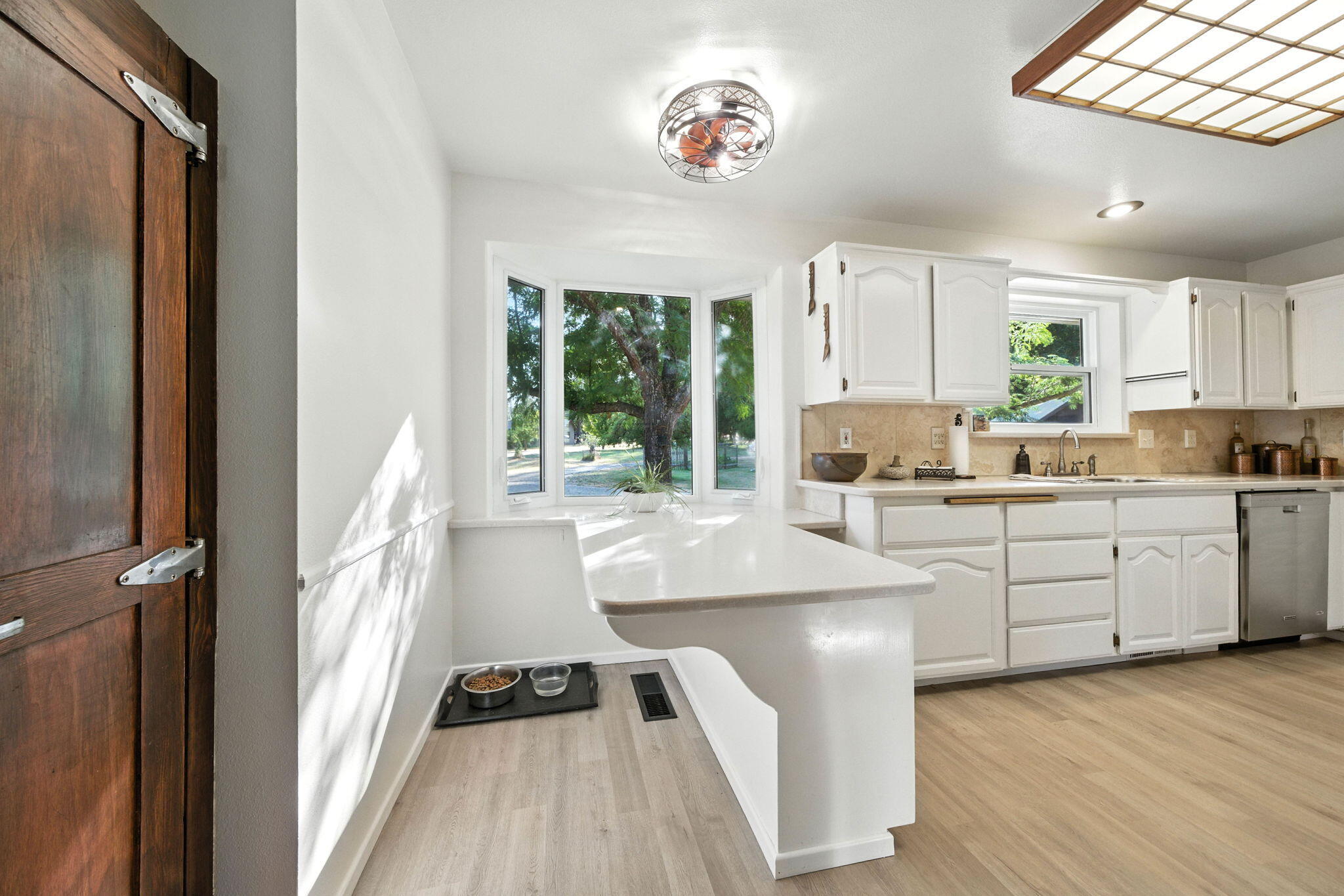 61 Chief George Lewiston, CA 96052 - Photo 32 of 101 a kitchen with a refrigerator a sink dishwasher a stove and white cabinets with wooden floor