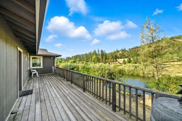 a backyard of a house with lots of green space and lake view