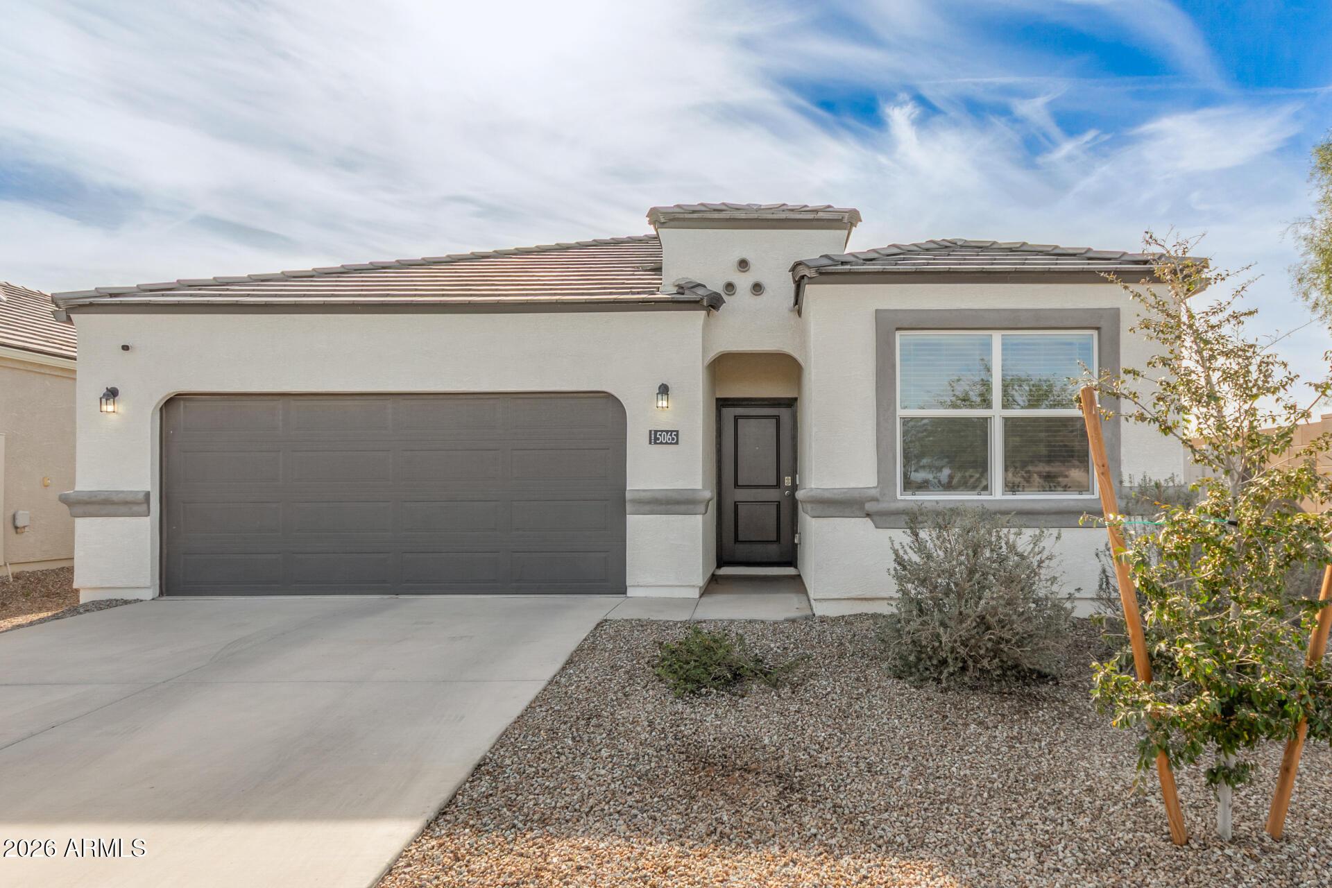 5065 East Emery Road San Tan Valley, AZ 85143 - Photo 1 of 33 a front view of a house with a garage