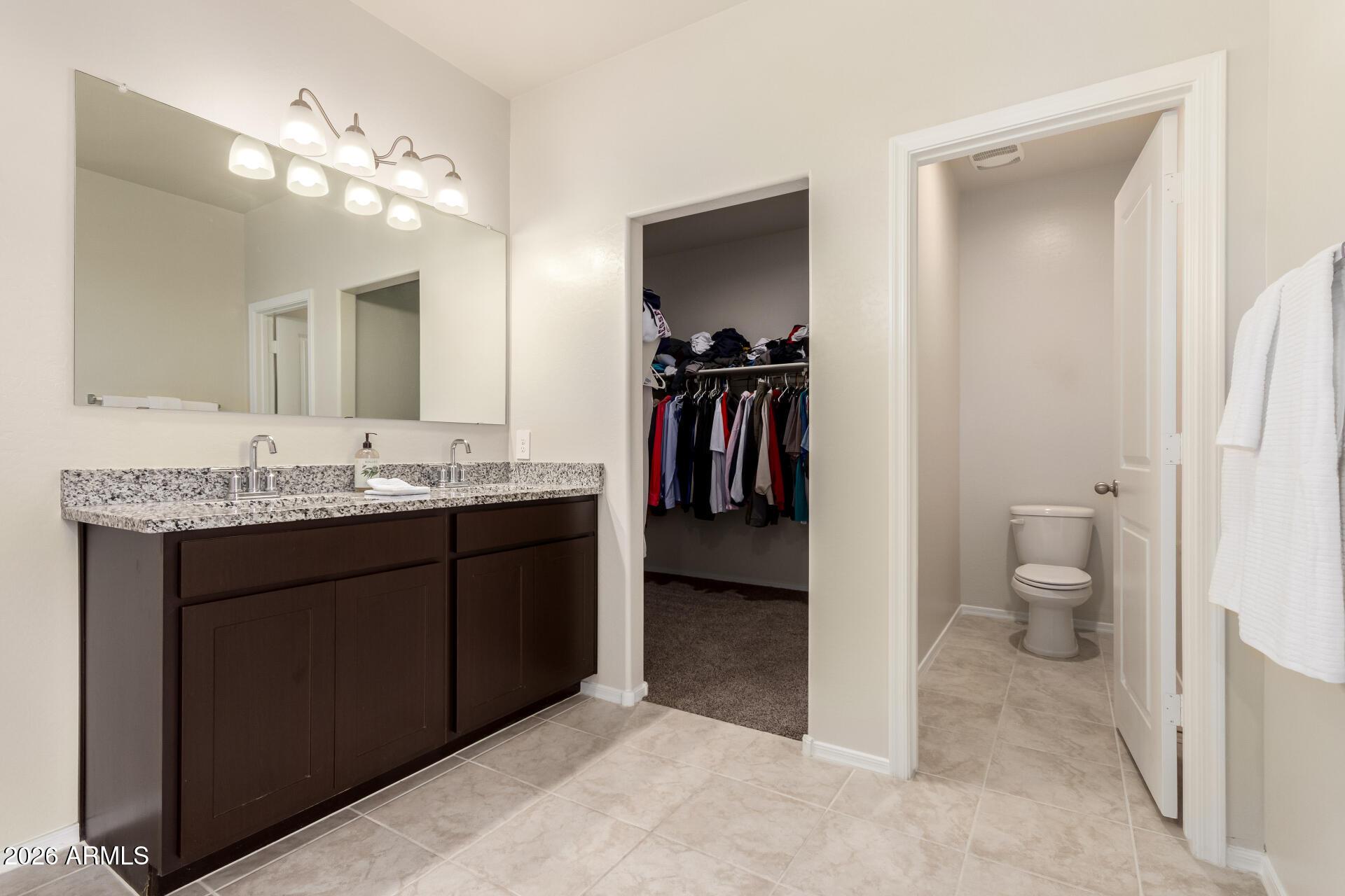 5065 East Emery Road San Tan Valley, AZ 85143 - Photo 13 of 33 a bathroom with a sink vanity and a toilet