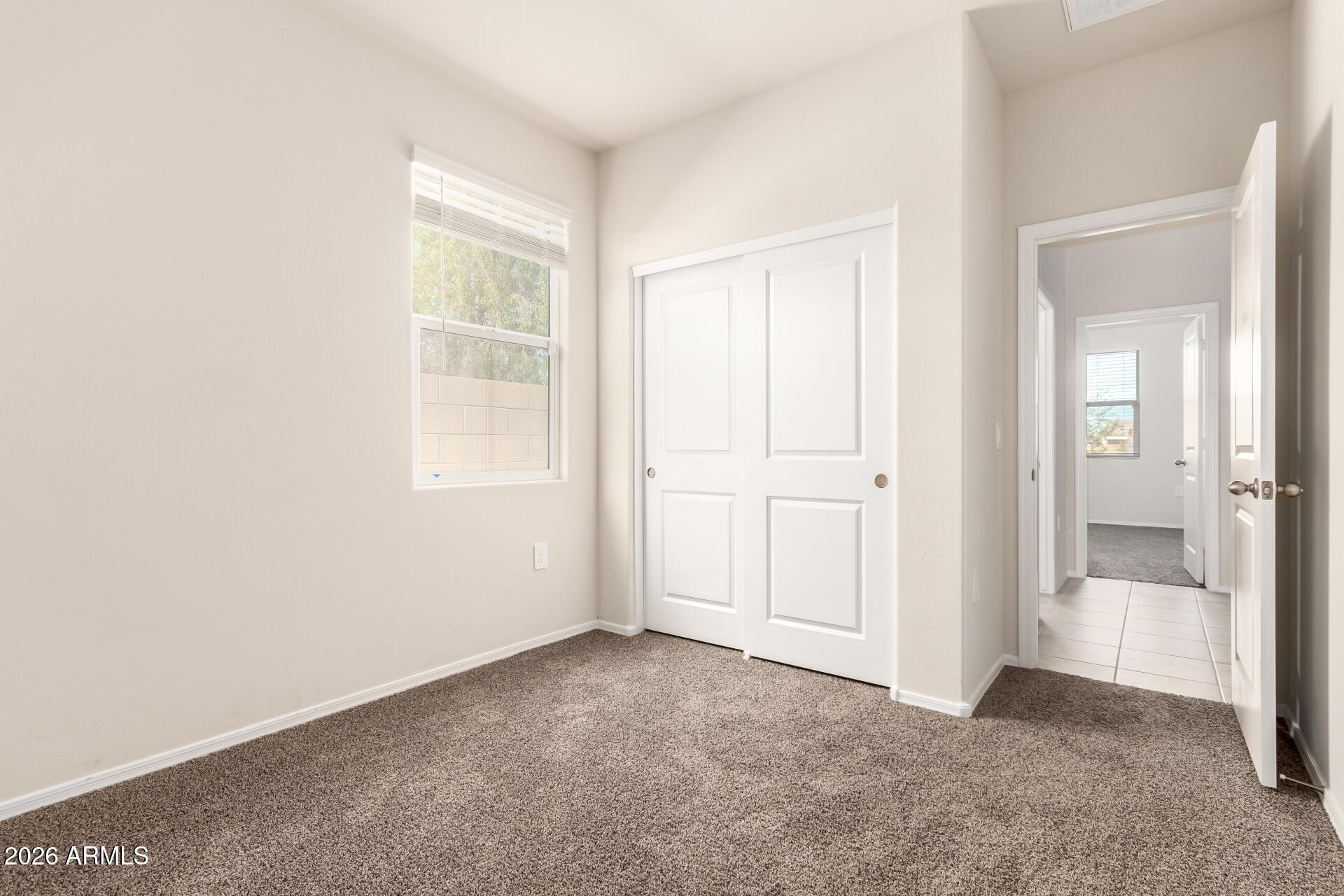 5065 East Emery Road San Tan Valley, AZ 85143 - Photo 18 of 33 an empty room with windows and bathroom