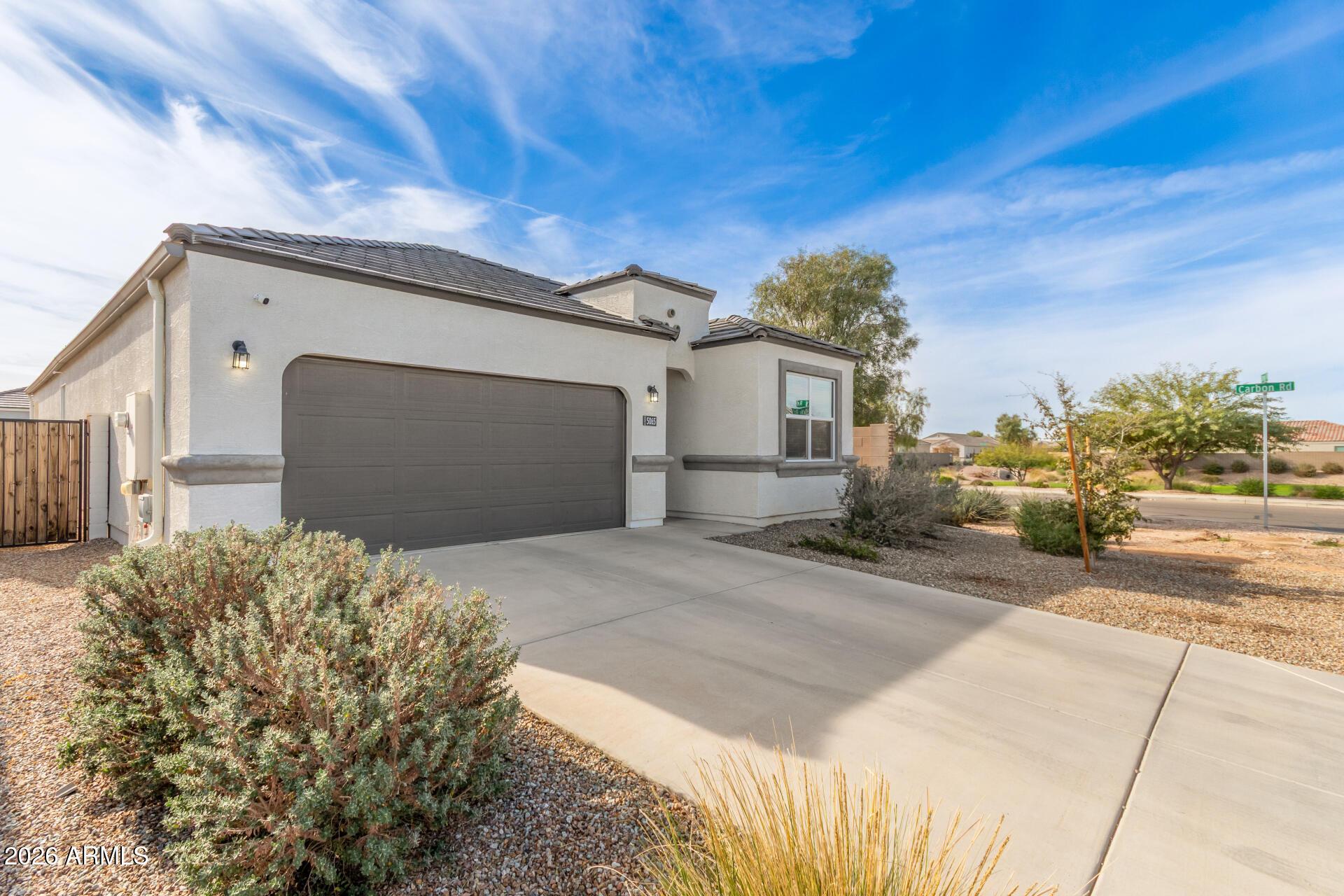 5065 East Emery Road San Tan Valley, AZ 85143 - Photo 2 of 33 a front view of a house with a yard and garage