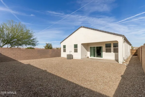 a view of a house with a backyard