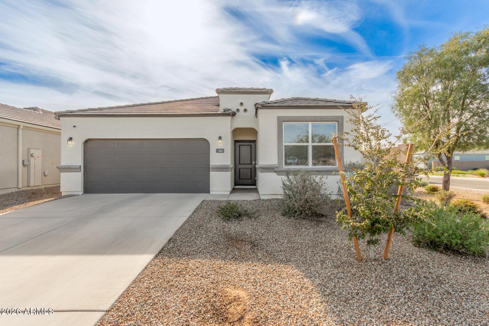 5065 East Emery Road San Tan Valley, AZ 85143 - Photo 31 of 33 front view of a house with potted plants