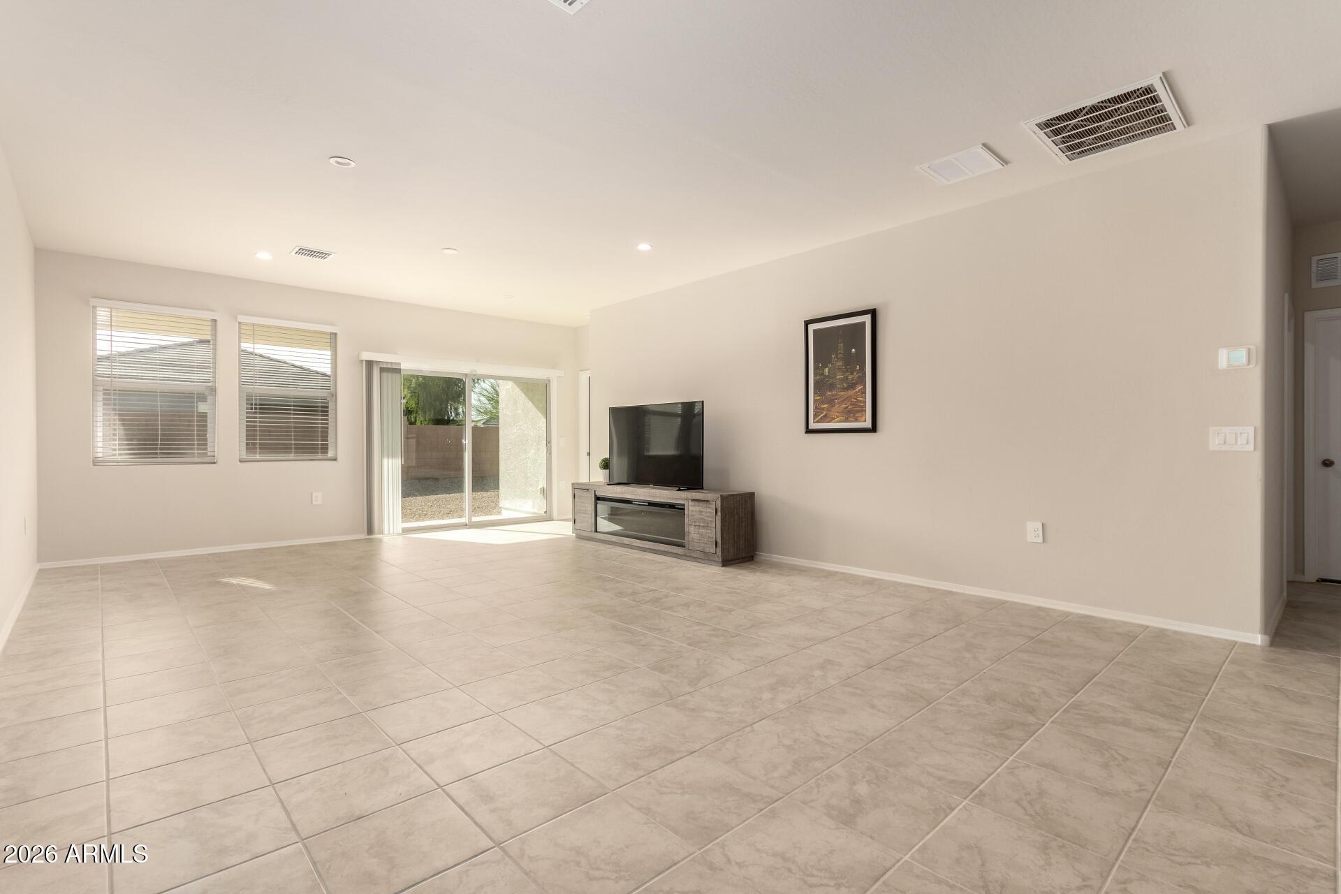 5065 East Emery Road San Tan Valley, AZ 85143 - Photo 6 of 33 an empty room with windows and fireplace