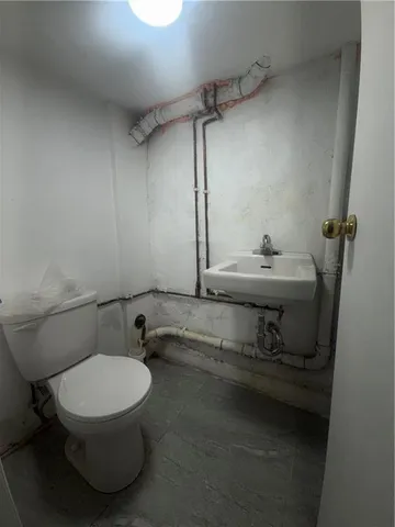 a bathroom with a toilet and a sink
