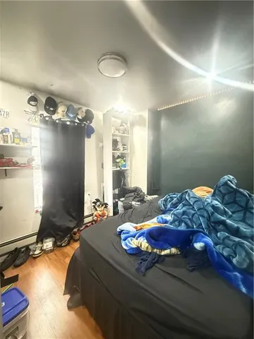 a bedroom with a bed and wooden floor