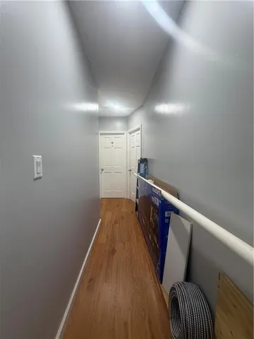 a view of hallway with wooden floor