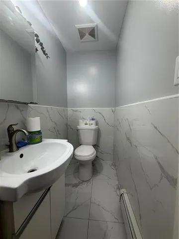 a bathroom with a sink a toilet and a mirror