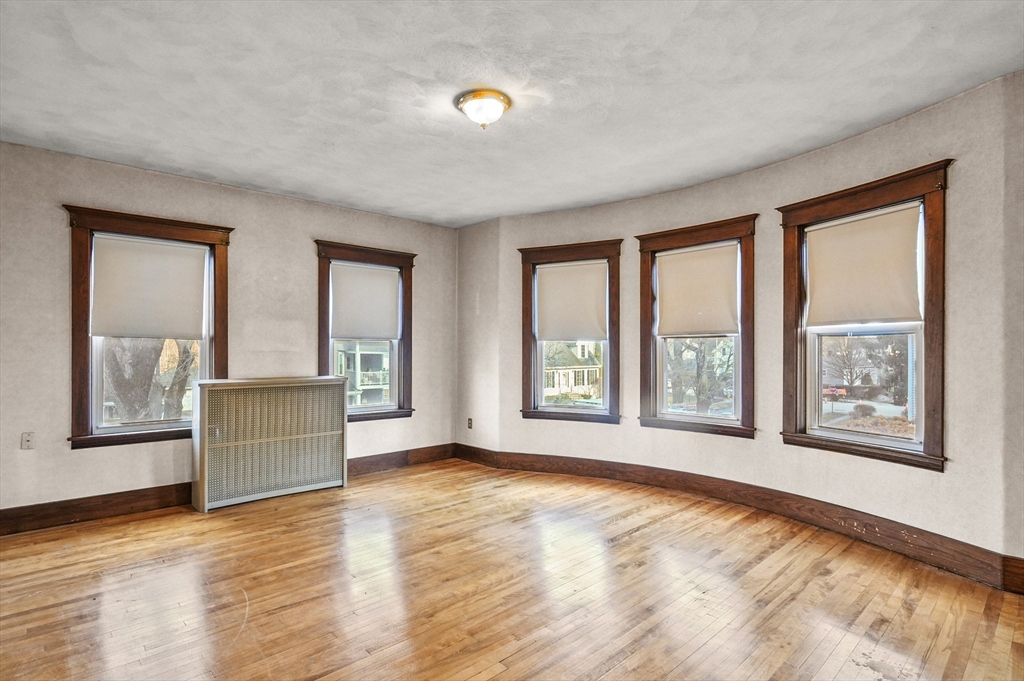3 Clearview Avenue Worcester, MA 01605 - Photo 5 of 42 a view of an empty room with a window and wooden floor