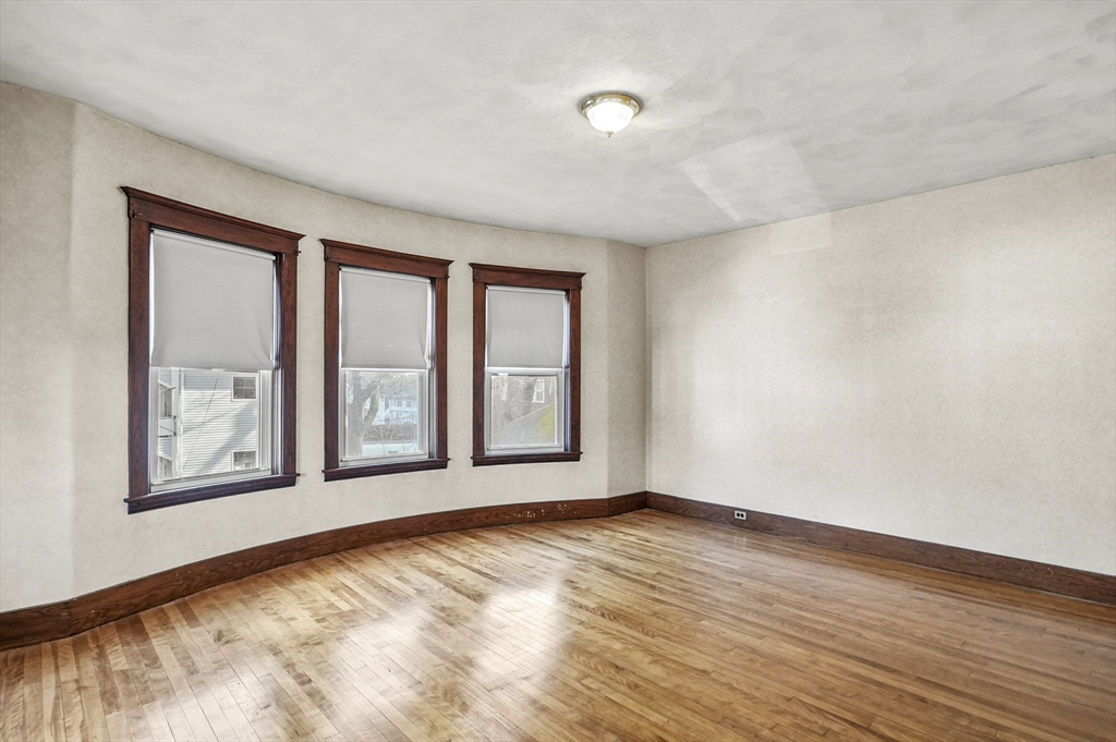 3 Clearview Avenue Worcester, MA 01605 - Photo 7 of 42 a view of an empty room with wooden floor and a window