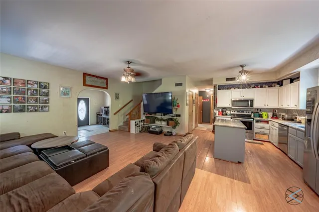 a living room with furniture and a wooden floor