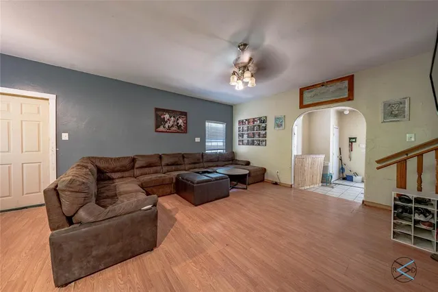 a living room with furniture and wooden floor
