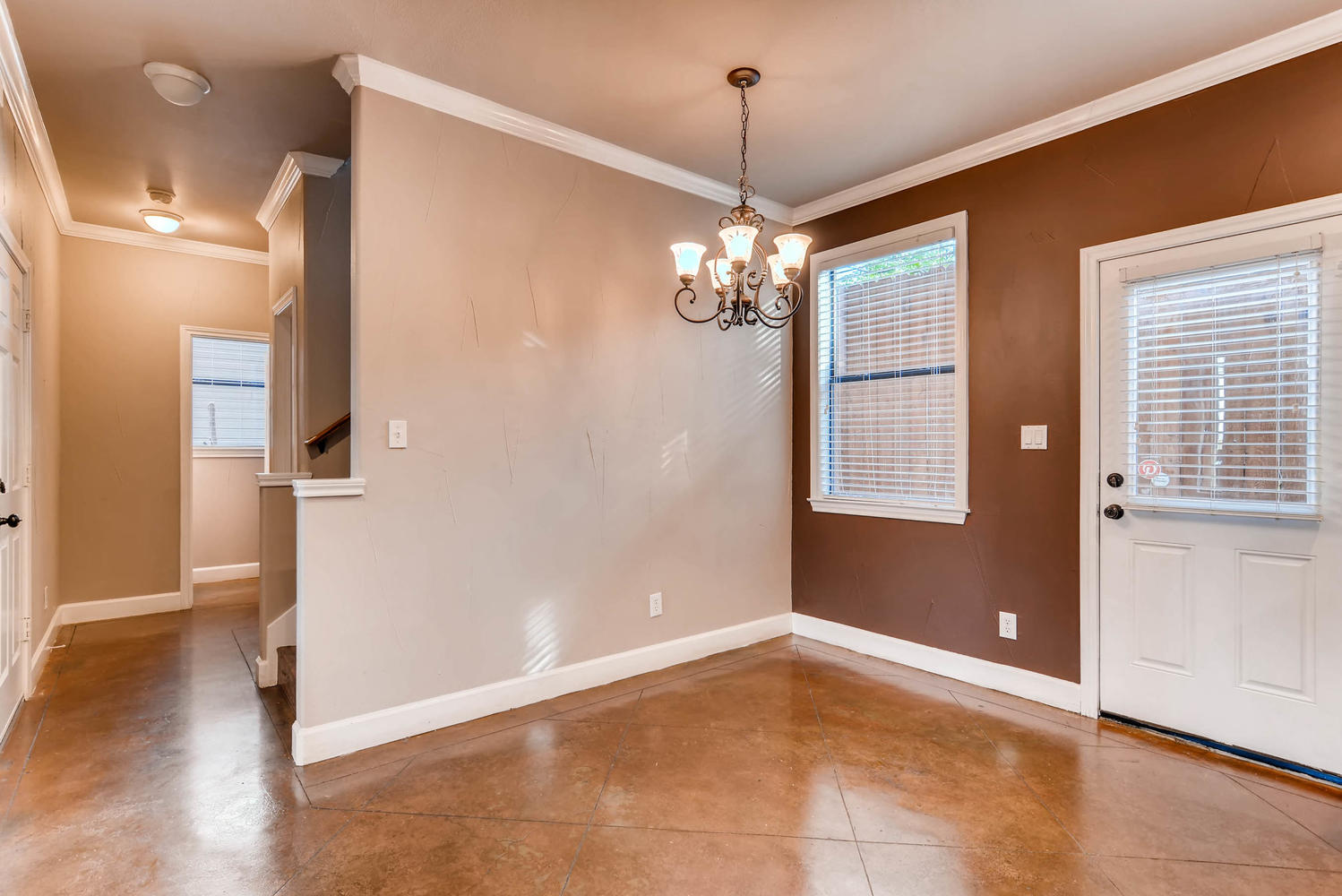 906 Juniper Street Austin, TX 78702 - Photo 11 of 28 a view of a livingroom with a chandelier wooden floor and front door