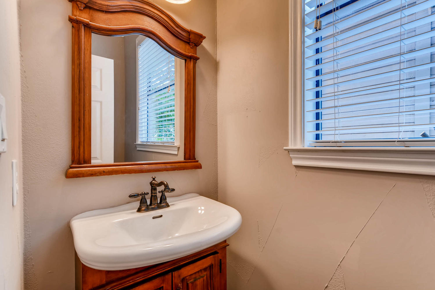 906 Juniper Street Austin, TX 78702 - Photo 13 of 28 a bathroom with a sink a mirror and a window