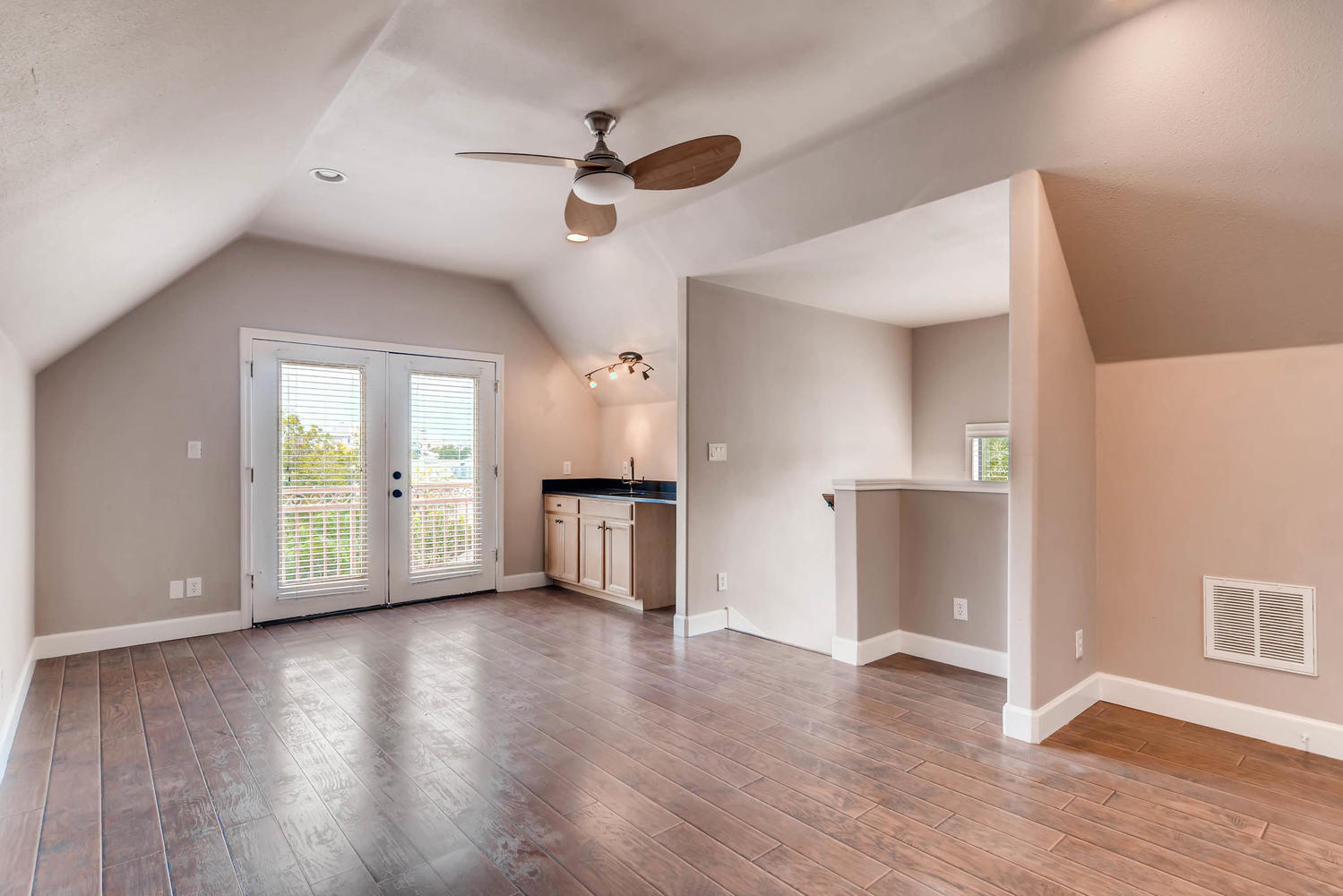 906 Juniper Street Austin, TX 78702 - Photo 23 of 28 a view of an empty room with window and wooden floor