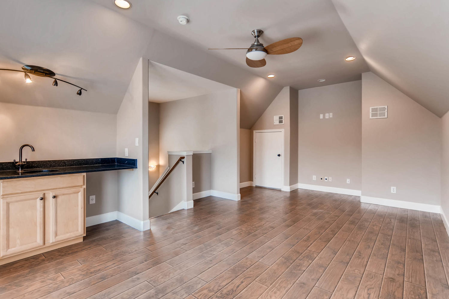 906 Juniper Street Austin, TX 78702 - Photo 24 of 28 a view of an empty room with wooden floor and a ceiling fan