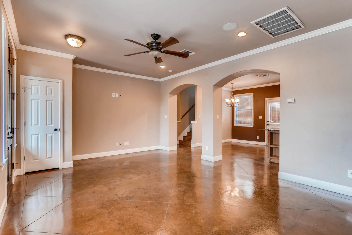 906 Juniper Street Austin, TX 78702 - Photo 6 of 28 a view of an empty room with wooden floor and a ceiling fan