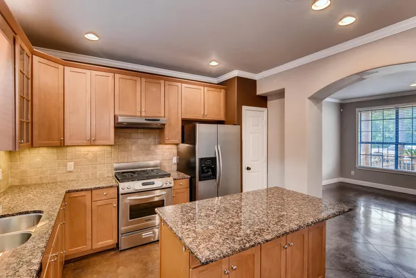 a kitchen with a stove a refrigerator and a sink