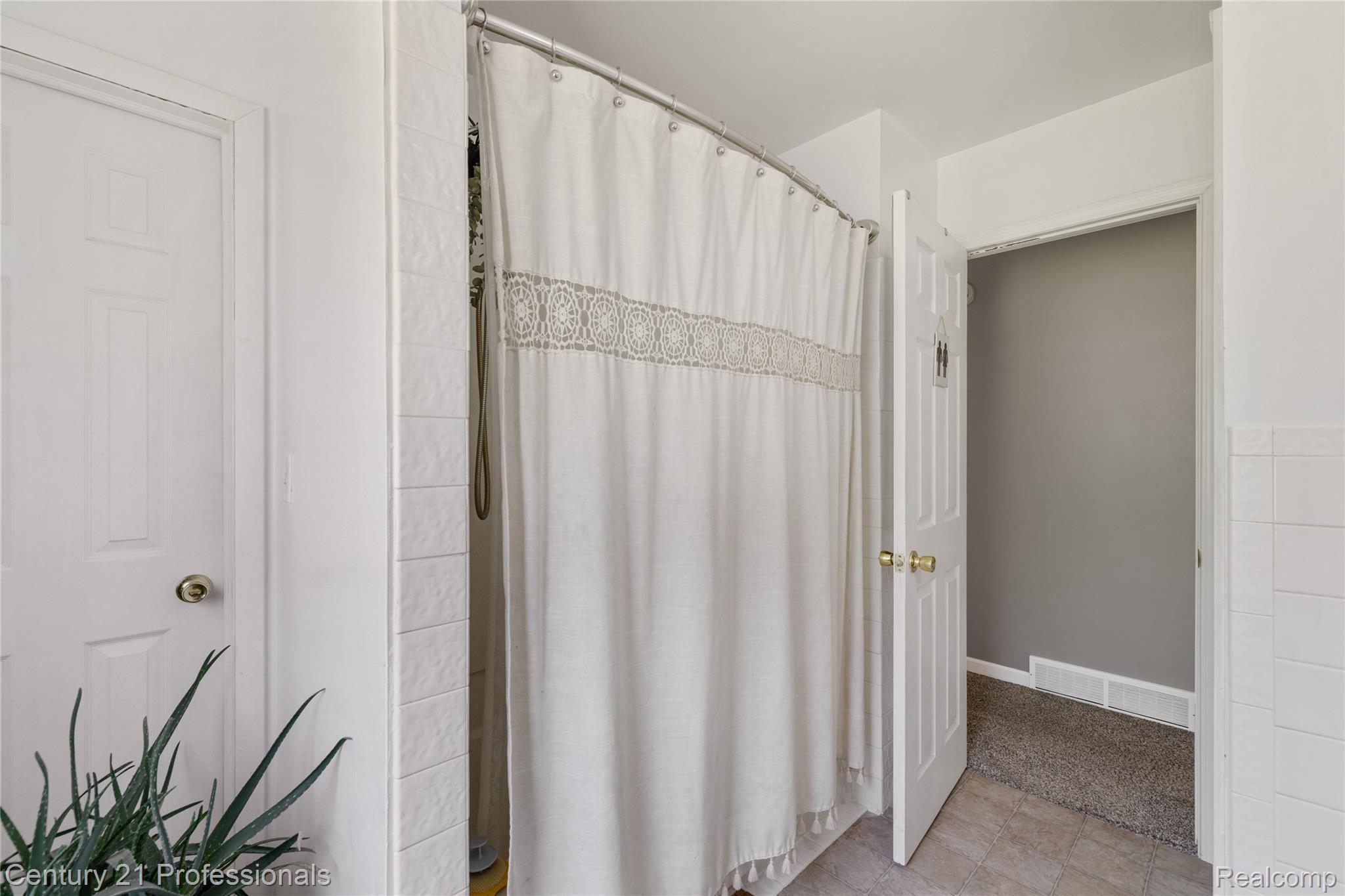 15037 Hogan Road Linden, MI 48451 - Photo 20 of 38 White paneled doors with brass hardware complimenting the neutral wall and floor finishes
